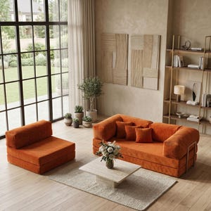 May include: An orange modular sofa and matching armchair set in a modern living room. The sofa has several orange throw pillows and sits on a light-colored rug. A square marble coffee table holds a vase of flowers.