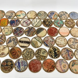 May include: A set of 30 round coasters made from repurposed rug scraps. Each coaster features a unique pattern and colour combination, creating a vibrant and eclectic look.