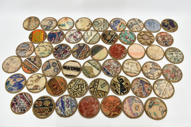 May include: A set of 30 round coasters made from repurposed rug scraps. Each coaster features a unique pattern and colour combination, creating a vibrant and eclectic look.