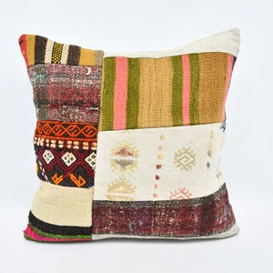 May include: A patchwork cushion cover featuring a mix of colours and patterns, including red, orange, brown, green, and white. The cushion cover is crafted from recycled materials and has a distinctive, handmade appearance.