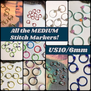May include: Assortment of colorful stitch markers in various colors, including green, blue, red, silver, and gold. The markers are 6mm in diameter and are labeled as US10/6mm. The text "All the MEDIUM Stitch Markers!" is displayed on the image.