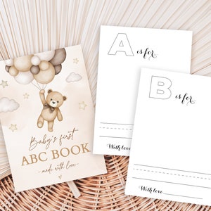 May include: A printable baby's first ABC book with a brown teddy bear holding balloons. The cover says "Baby's first ABC BOOK - made with love."