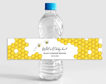 May include: Water bottle label with a honeycomb pattern and two cartoon bees. The text on the label reads "What will baby bee? Ella's Gender Reveal 04.05.2024".