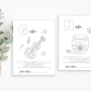 May include: Black and white printable coloring page featuring the letter G and a guitar with the text "G is for... Guitar". The page also includes musical notes and the text "Made with love".