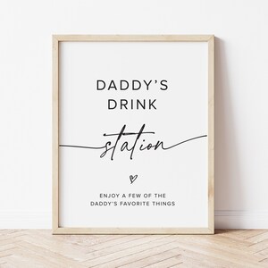 May include: A printable sign with the text "Daddy's Drink Station" in black script font. The sign also includes the text "Enjoy a few of the Daddy's favorite things" in black font.