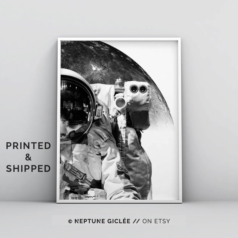 May include: Black and white photograph of an astronaut in a spacesuit with the moon in the background.