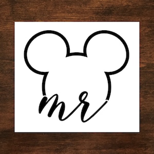 May include: Black and white silhouette of Mickey Mouse ears with the word "mr" written underneath.