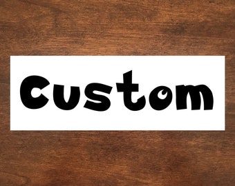 May include: A white sign with the word "custom" written in black, bold, and playful lettering.