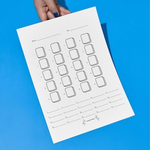May include: A white paper with a grid of numbered boxes and lines, held against a blue background. The paper has the words "Brand" and "Set" at the top, and the text "Handy McHandy" at the bottom.