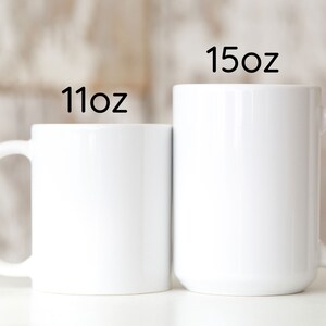 two white coffee mugs sitting next to each other