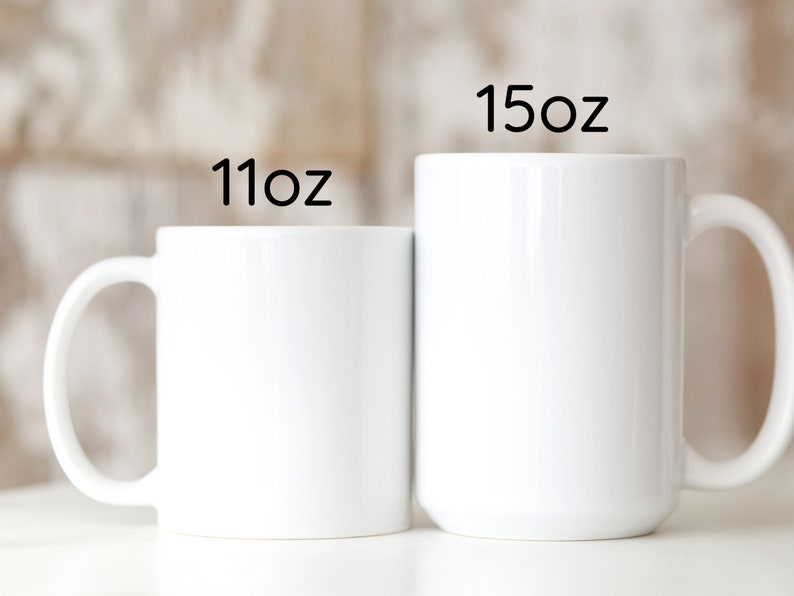 two white coffee mugs sitting next to each other