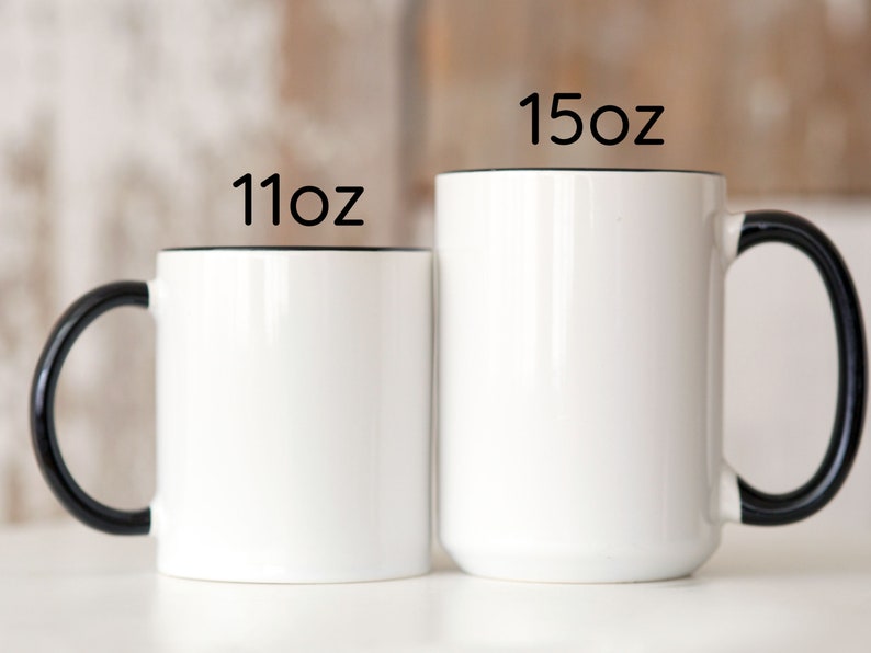 two black and white coffee mugs sitting next to each other