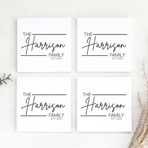 May include: Four white square tiles with black text. Each tile reads "The Harrison Family Est. 2022". The text is in a cursive font.