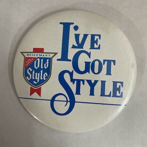 May include: A white round button with blue text that reads "I've Got Style". A smaller shield-shaped logo in the lower left corner reads "Heileman's Pure Genuine Old Style".