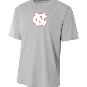 May include: A gray t-shirt with a white "NC" logo outlined in red.