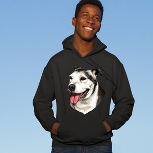 May include: A black hooded sweatshirt with a white and black dog illustration on the front. The dog is smiling with its tongue sticking out.