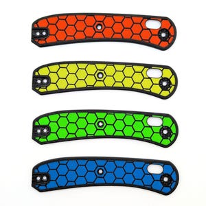 May include: Four different colored knife scales with a honeycomb pattern. The scales are orange, yellow, green, and blue.