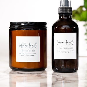 May include: A soy wax candle and room fragrance set in amber glass bottles with black lids and sprayers. The candle label reads "citrus basil", and the room fragrance reads "lemon basil". Both are handmade in Minnesota, USA.