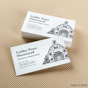May include: White business cards with black text and a line drawing of a barn. The text reads "Golden Roots Homestead Produce & Canned Goods" with contact information below.