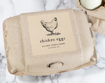 May include: A brown cardboard egg carton with a sticker that says "chicken eggs" and "Silver Creek Farm, Shakopee, MN". The sticker features a black and white illustration of a chicken.