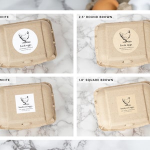 May include: Four cardboard egg cartons with different sizes and colors. Two cartons are 2.5 inches round, one is white and one is brown. Two cartons are 1.8 inches square, one is white and one is brown. Each carton has a sticker with a chicken illustration and text. The round cartons have "fresh eggs" stickers. The square cartons have "backyard eggs" stickers.