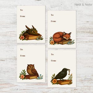 May include: Four gift tags featuring a dragon, fox, owl, and crow, each depicted on a book with floral details. The tags include spaces for "To:" and "From:" and the text "Nest & Note Print Co."