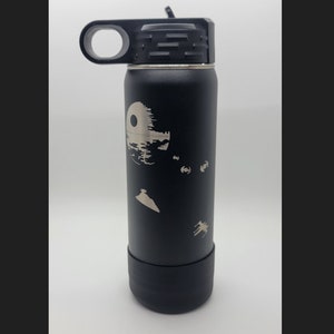 May include: Black stainless steel water bottle with a laser-etched design of the Death Star from Star Wars. The bottle has a black lid with a carrying loop.