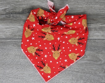 May include: Red bandana with a white star and reindeer pattern.