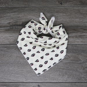 May include: White bandana with a black and red vampire teeth pattern.