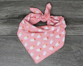May include: Pink bandana with a white ghost pattern wearing cowboy hats.