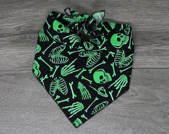 Puede incluir: Bandana negra con un patrón de esqueleto y calavera verde.