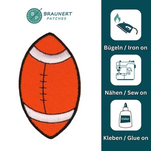 May include: An orange and white embroidered iron-on patch of an American football. The patch is labeled "B&uuml;geln / Iron on", "N&auml;hen / Sew on", and "Kleben / Glue on".