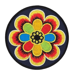 May include: A colorful embroidered flower patch with red, yellow, green, blue, and black accents. The flower is surrounded by a dark blue circle.