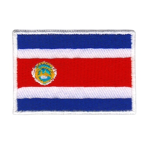 Peut inclure: Écusson brodé représentant le drapeau du Costa Rica. Le drapeau est bleu, blanc et rouge avec un emblème circulaire au centre.