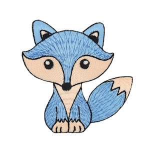 Könnte beinhalten: Blaue gestickte Fuchs-Applikation mit hellbrauner Nase und Augen. Der Fuchs sitzt mit seinem Schwanz hinter sich eingerollt.