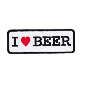 May include: White rectangular patch with black border and black text that reads "I ♥ BEER" with a red heart.