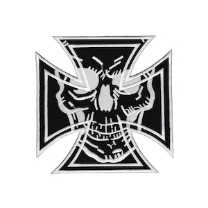 Peut inclure: Patch thermocollant brodé noir et blanc représentant un crâne avec une croix derrière.
