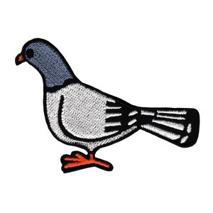 Op de afbeelding: Een geborduurde patch met een cartoon-duif, met witte en grijze stiksels, een zwarte omtrek en oranje poten.