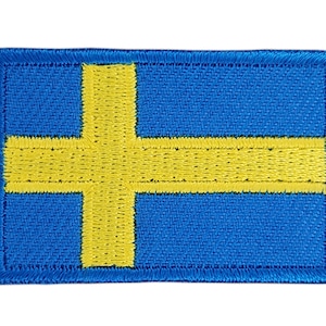 Könnte beinhalten: Ein gestickter schwedischer Flaggen-Patch in Gelb auf blauem Hintergrund.