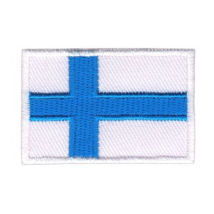 Peut inclure: Un patch en tissu blanc avec une croix bleue, représentant le drapeau de la Finlande.