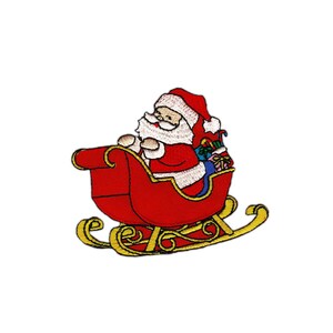May include: Red and white embroidered patch of Santa Claus riding in a red sleigh with gold trim. Santa is holding a bag of gifts.