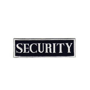 Peut inclure: Un patch rectangulaire noir avec du texte brodé blanc qui dit "SECURITY".
