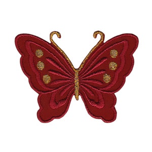 Op de afbeelding: Rode geborduurde vlinderpatch met gouden accenten. De vlinder heeft een gedetailleerd ontwerp met een textuur.