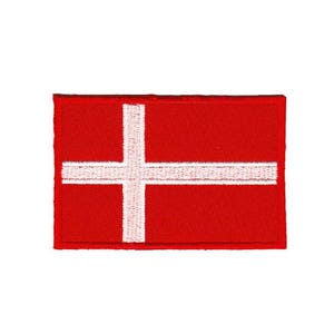 May include: A red embroidered patch featuring a white Scandinavian cross. The patch is ideal for adding a touch of Danish pride to your belongings.