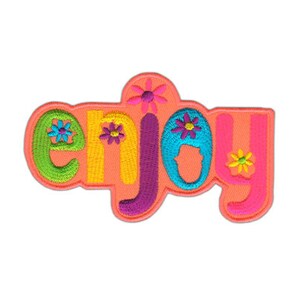 Könnte beinhalten: Ein rosa gestickter Aufnäher mit dem Wort "enjoy" in bunten Buchstaben und Blumen.