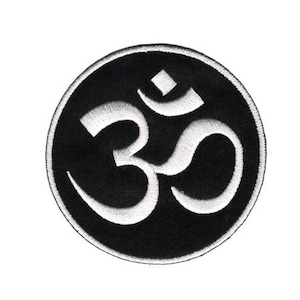 May include: A black and white embroidered patch featuring the Om symbol in a circle.