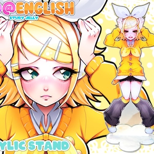 Może przedstawiać: Akrylowy stojak z ilustracją w stylu mangi postaci z żółtymi włosami i żółtym strojem. Stojak ma napis "BAD@ENGLISH" i "ACRYLIC STAND". Postać jest w dynamicznej pozie.