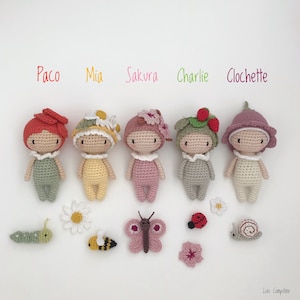 Puede incluir: Cinco mu&ntilde;ecas de ganchillo hechas a mano, cada una con un sombrero y un vestido &uacute;nicos con temas florales o de la naturaleza. Las mu&ntilde;ecas se llaman Paco, Mia, Sakura, Charlie y Clochette. Hay insectos y flores de ganchillo alrededor de las mu&ntilde;ecas.