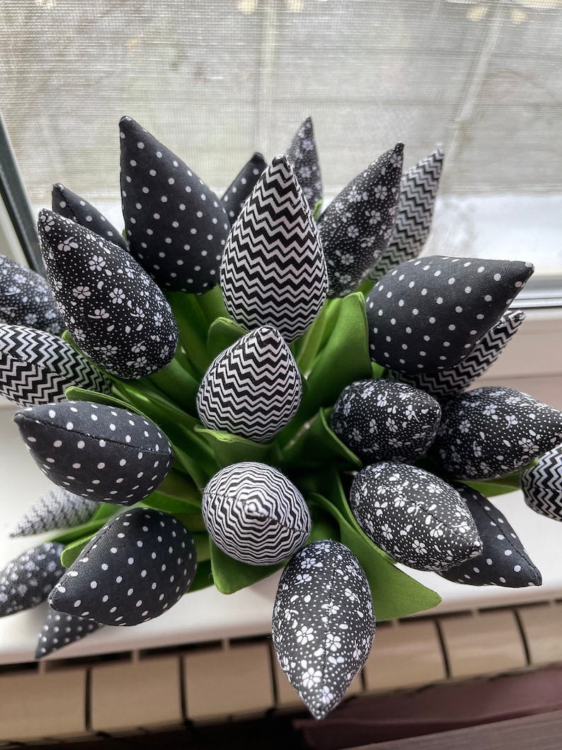 May include: A bouquet of black and white fabric tulips with various patterns, including polka dots, zigzags, and floral prints.