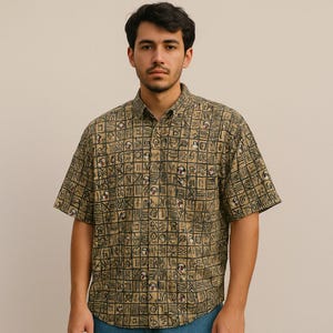 May include: A short-sleeved button-down shirt with a tan background and a repeating black and red square pattern. The shirt has a classic collar and is made of a lightweight fabric.